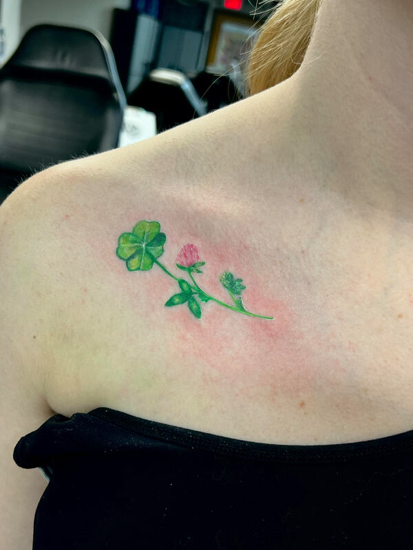 Color realism clover tattoo on a collar bone.