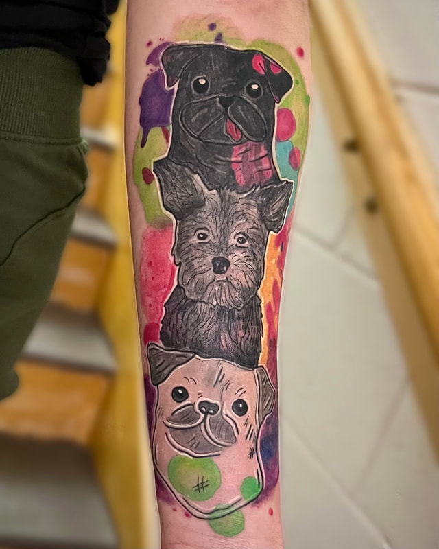 Watercolor dogs from child's sketches, tattoo on a woman's forearm.