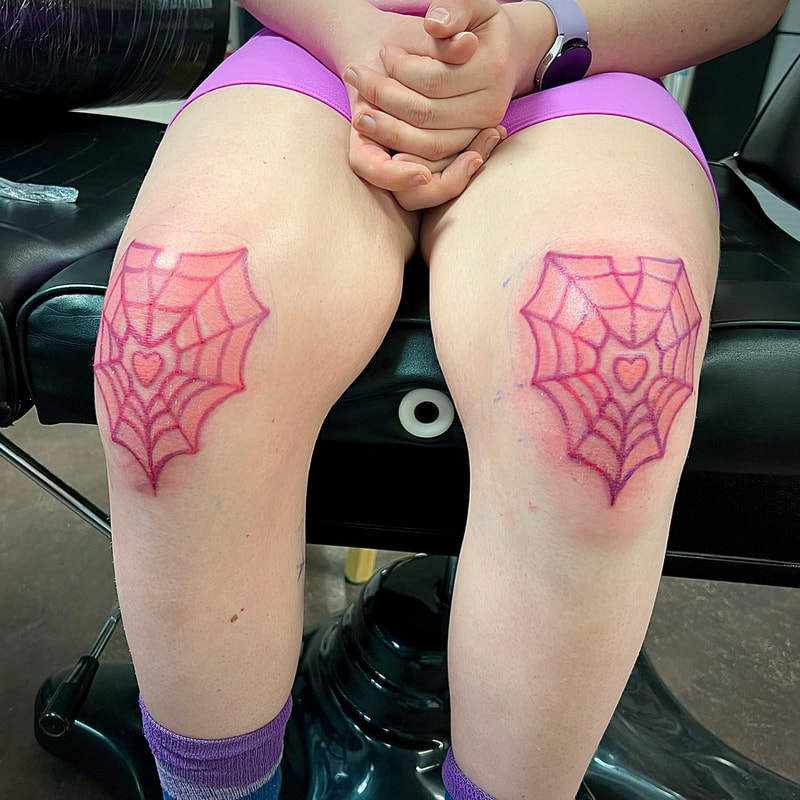 Heart shaped spider web tattoo flash on knees by Tyranicorn.