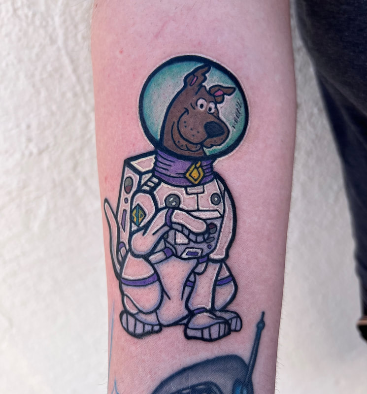 Scooby Doo dressed as an astronaut on a forearm.